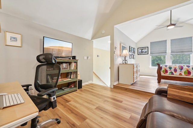 office space with ceiling fan, light hardwood / wood-style floors, and vaulted ceiling