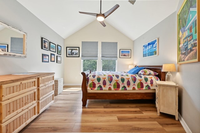 bedroom with ceiling fan, light wood-type flooring, and lofted ceiling