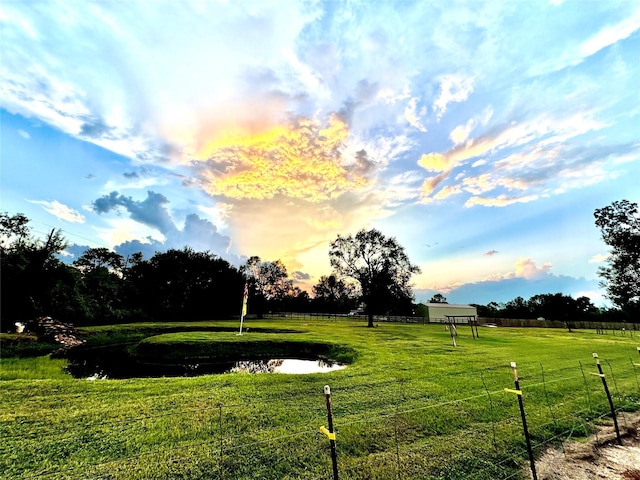 view of community with a lawn and a water view