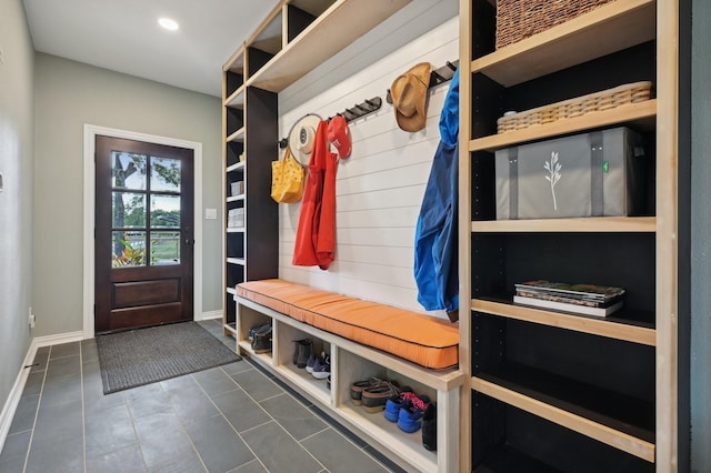 mudroom featuring dark tile patterned floors