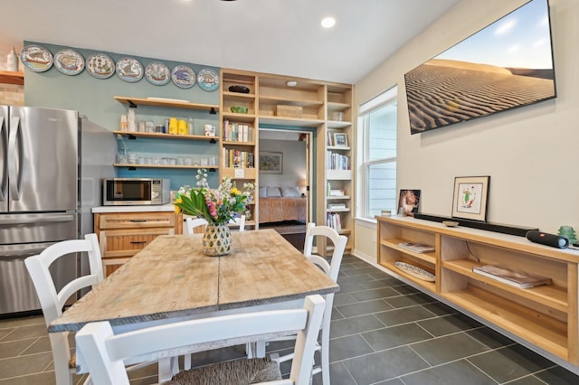 dining area featuring dark tile patterned floors