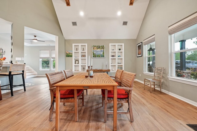 dining area featuring built in shelves, light hardwood / wood-style floors, plenty of natural light, and ceiling fan