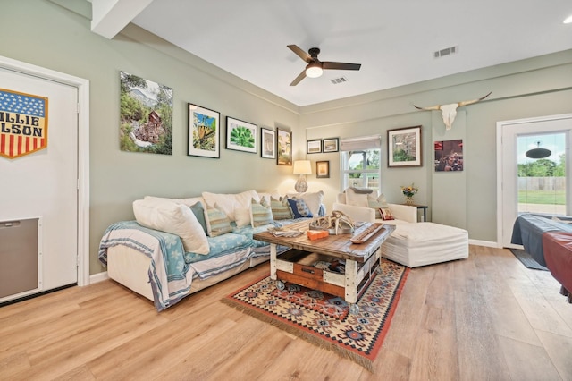 living room with ceiling fan, wood-type flooring, and a wealth of natural light