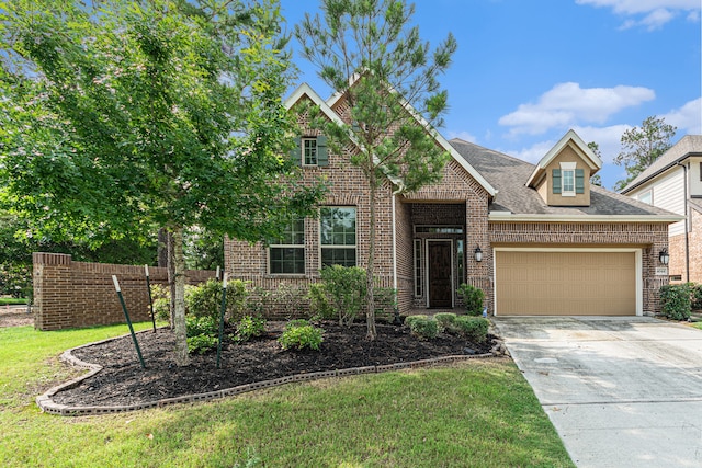 view of front of property with a front yard and a garage