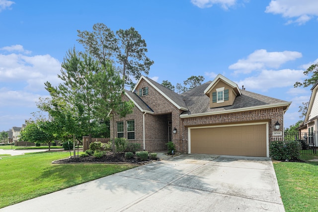 view of front facade with a front yard and a garage