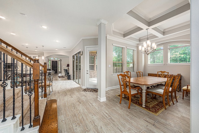 dining room featuring light wood-type flooring, coffered ceiling, crown molding, beamed ceiling, and a chandelier