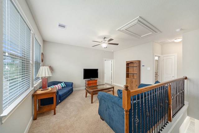 carpeted living room with ceiling fan