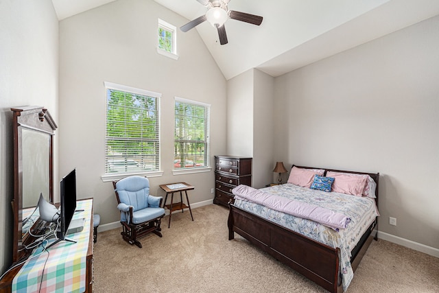 carpeted bedroom with ceiling fan and high vaulted ceiling