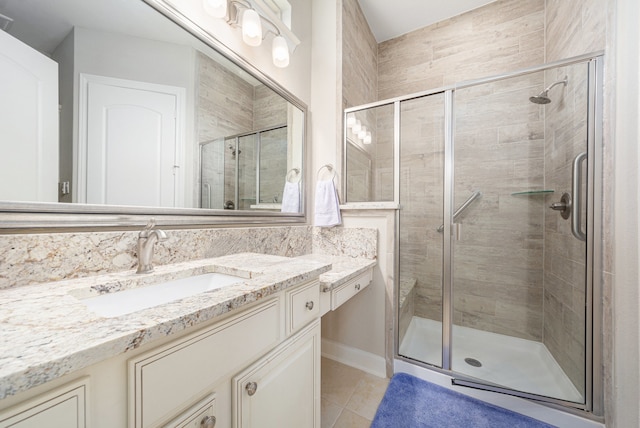 bathroom with tile patterned flooring, vanity, and an enclosed shower