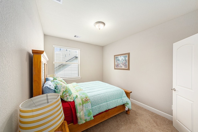 bedroom featuring light carpet