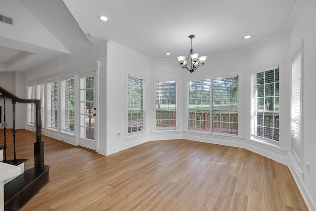 unfurnished dining area with a notable chandelier, a healthy amount of sunlight, crown molding, and light hardwood / wood-style flooring