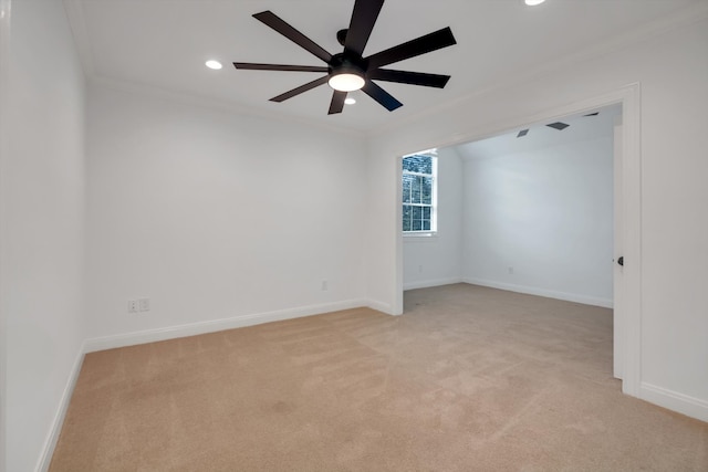 carpeted empty room with crown molding and ceiling fan