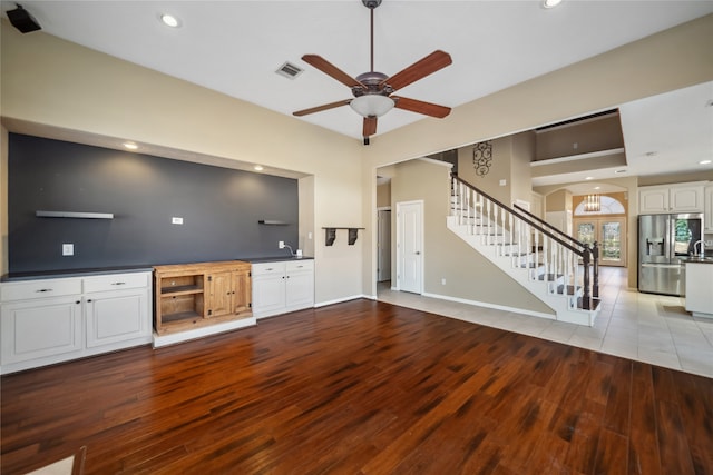 unfurnished living room featuring ceiling fan and light hardwood / wood-style floors