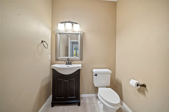 bathroom featuring toilet, vanity, and tile patterned floors