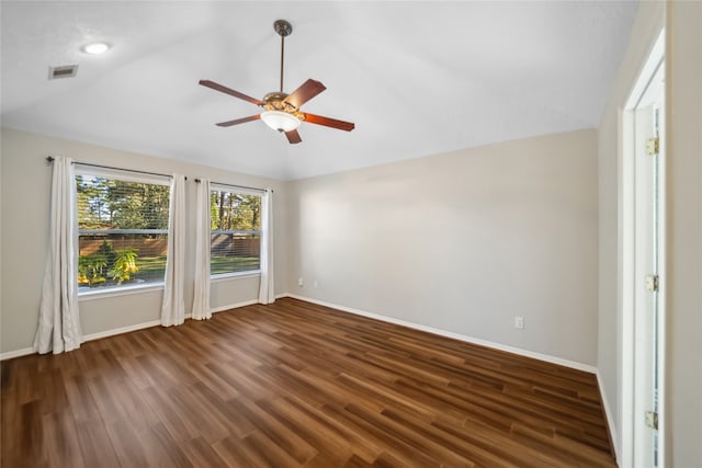 empty room with ceiling fan, dark wood-type flooring, and lofted ceiling