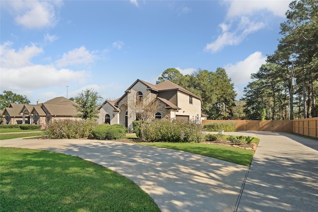 view of front of home with a garage and a front lawn