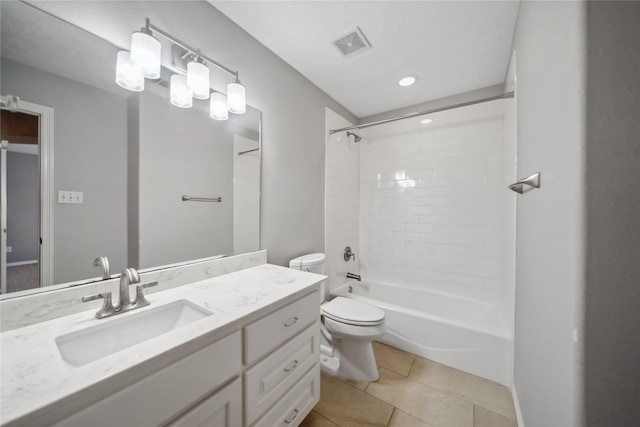 full bathroom featuring tile patterned flooring, vanity, tiled shower / bath combo, and toilet