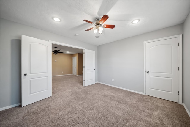 unfurnished bedroom with light carpet and ceiling fan