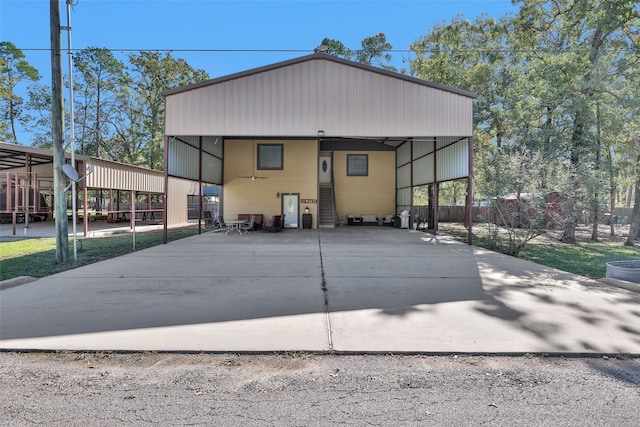 back of property with a carport