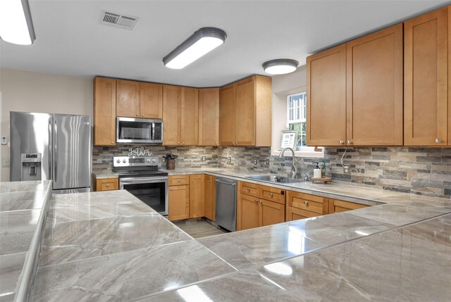 161 Cayman St, Point Blank, TX 77364 - kitchen featuring stainless steel appliances, a sink, tasteful backsplash, and light countertops
