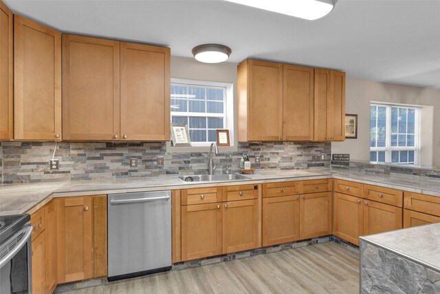 161 Cayman St, Point Blank, TX 77364 - kitchen featuring stainless steel appliances, a sink, light wood-type flooring, backsplash, and light countertops