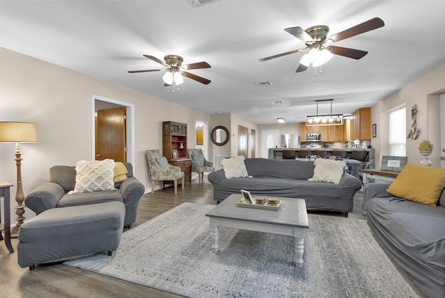 living room featuring dark hardwood / wood-style floors and ceiling fan