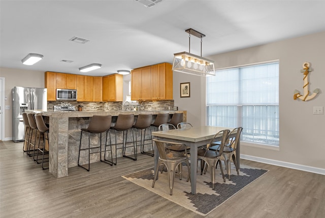 dining room with wood-type flooring