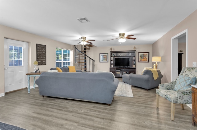 living room featuring ceiling fan and light wood-type flooring