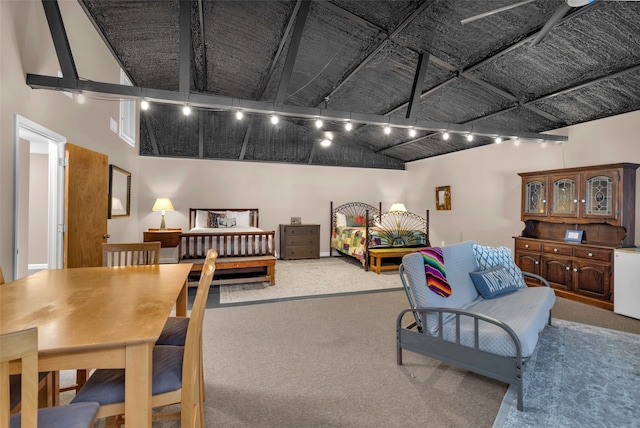 interior space with beam ceiling, track lighting, and high vaulted ceiling