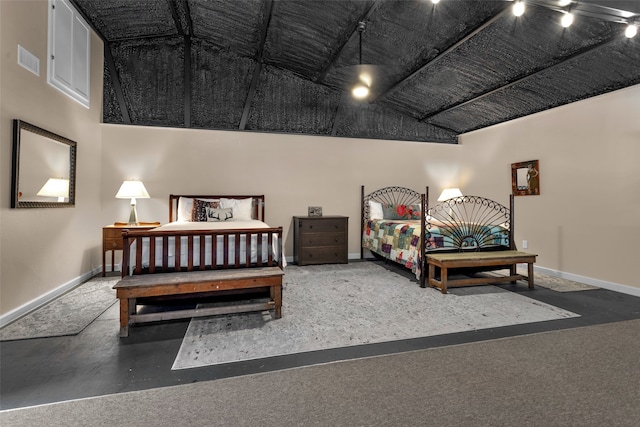 bedroom featuring rail lighting and vaulted ceiling