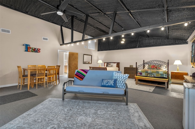 living room with a high ceiling and ceiling fan