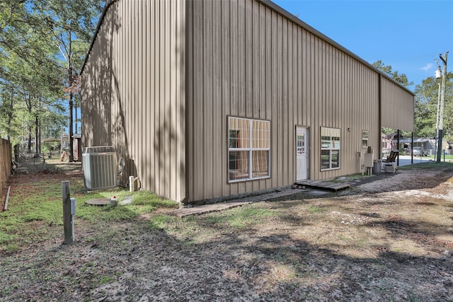 back of house featuring central air condition unit