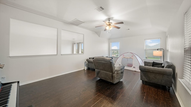 living room with ceiling fan and dark hardwood / wood-style flooring