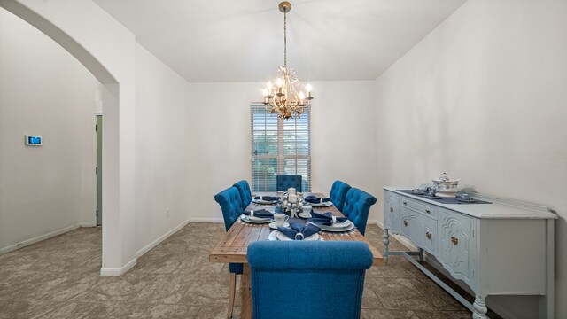 dining area featuring an inviting chandelier