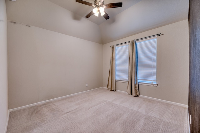 carpeted spare room with vaulted ceiling and ceiling fan