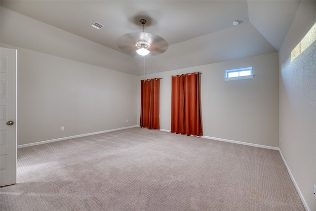 carpeted spare room with ceiling fan and lofted ceiling