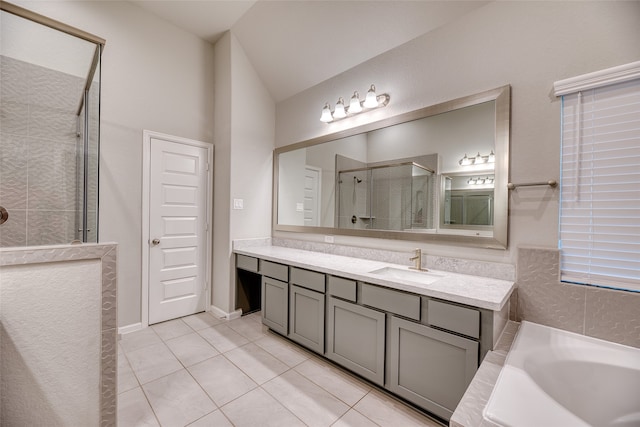 bathroom featuring vanity, separate shower and tub, lofted ceiling, and tile patterned floors