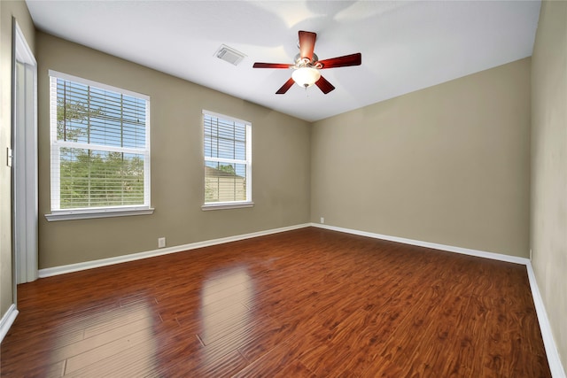 spare room featuring ceiling fan and dark hardwood / wood-style flooring