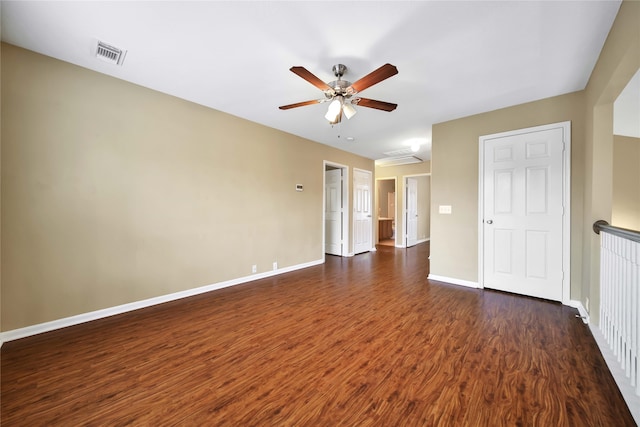 empty room with dark hardwood / wood-style flooring and ceiling fan