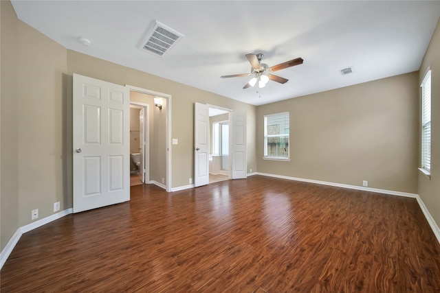 unfurnished room featuring ceiling fan and dark wood-type flooring