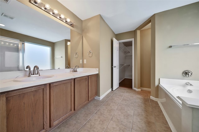 bathroom featuring vanity, independent shower and bath, and tile patterned floors