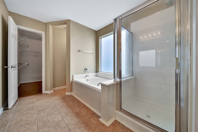 bathroom with tile patterned floors and plus walk in shower