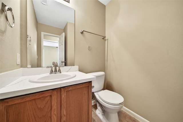 bathroom featuring vanity, toilet, and tile patterned flooring