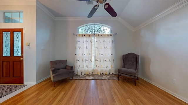 unfurnished room with ornamental molding, ceiling fan, and light wood-type flooring