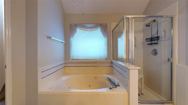 bathroom featuring vaulted ceiling and independent shower and bath