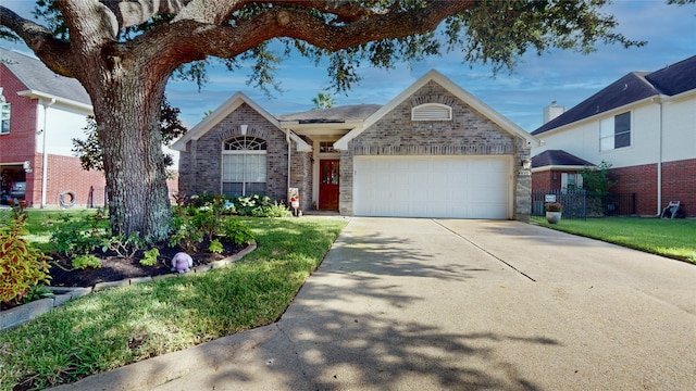 view of front of home with a front yard and a garage