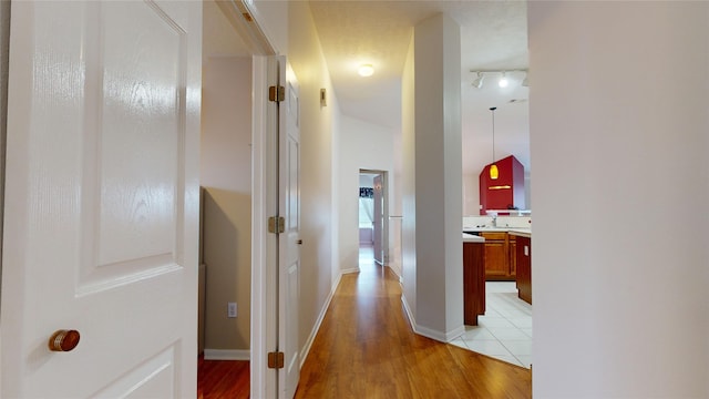 hallway with light hardwood / wood-style floors