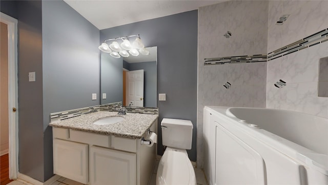 bathroom featuring vanity, a bath, and toilet