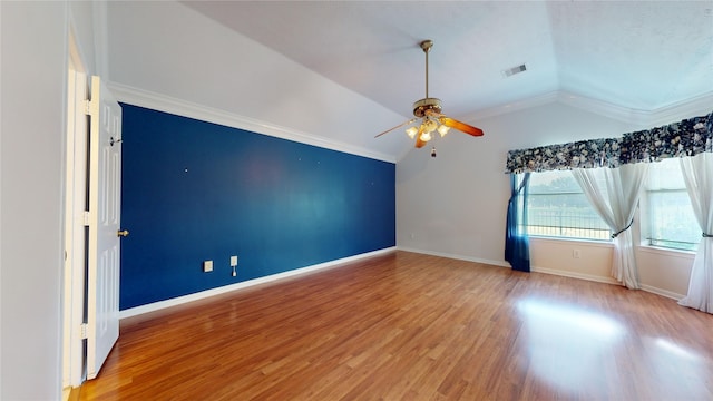 empty room featuring ceiling fan, ornamental molding, lofted ceiling, and hardwood / wood-style flooring