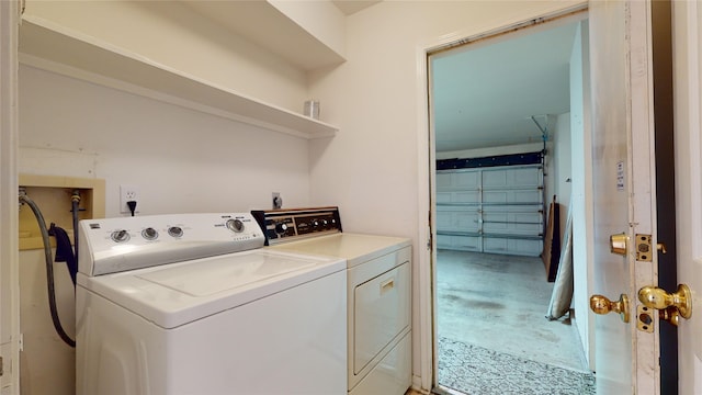 clothes washing area with washing machine and clothes dryer